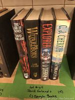 Photo of four fantasy hardback books by David Farland and CJ Cherryh showing spines and partial front covers.