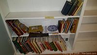 Bookshelves with various books including colorful cookbooks and art books