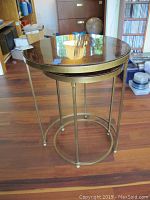 Large round nesting table with brass base and polished stone top