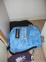 Blue Aero Bed pillow top air mattress in blue protective carry bag with shoulder strap.