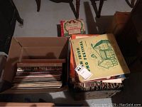 Photo showing two boxes filled with vinyl records, including visible album cover for 'Irish Song Festival'