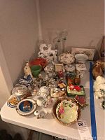 Full table view of all items including NAO figurine, multiple small figurines, plates, and boxes