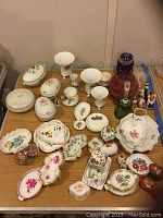 Full overhead view of assorted porcelain items and glass epergnes on table