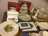 Full view of lot contents showing various Lenox Christmas and holiday-themed items including plates with fruit decoration, trays, candlesticks, frames, boxed Nutcracker figurine