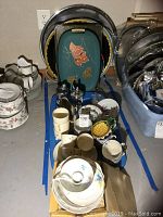 Vintage serving trays, bowls, cups arranged on table