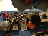 Overview of multiple small boxes, scissors, buttons, and girls' accessories grouped together
