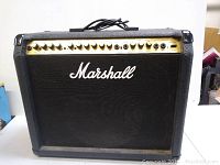 Front view showing black tolex, gold control panel, knobs and grille cloth