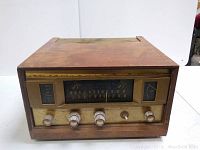 Front view of Fisher Model 500 tube amplifier showing wood casing and control panel with tuning dial and knobs.