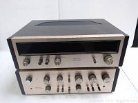 Front view of two vintage Pioneer components stacked, showing the brushed silver panels with controls and branding.