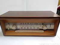 Front view of Nordmende Model 3004c receiver showing wood cabinet and control panel with frequency dial and knobs.