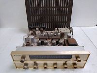 Front view showing metal front panel with tuning dial and control knobs