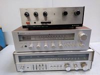 Top unit is Kenwood KA-2002 stereo amplifier with three knobs and switches. Middle unit is Sherwood S-7250 CP stereo receiver with analog tuner and multiple control knobs. Bottom unit is Fisher RS-2003 equalizer amplifier with sliders and knobs.