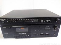 Front view of Telefunken TT200 tuner and TC200 tape deck showing frequency dial, cassette window, control buttons and knobs.