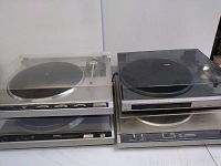 Four vintage turntables stacked: JVC QLF300 and Technics SL-210 visible with dust covers.