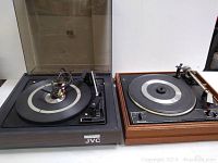 Wide view showing both vintage turntables side by side, JVC on left and Garrard on right
