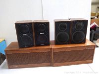 Full view showing four speakers: two large Tandberg speakers with wooden grille fronts and two smaller Soma speakers on top.