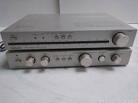 Front view stacked: tuner above preamp showing knobs, sliders, and tuning scale