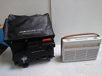 Front view of Minolta Sound 7000 audio recorder in black vinyl case alongside white Braun radio