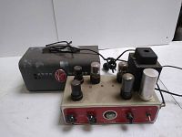 Top-left view of amplifier chassis with removable metal cover and vacuum tubes