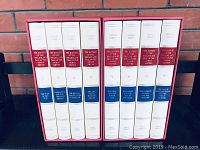 Front view of 8 hardcover volumes in red slipcases showing spine titles and volume numbers.