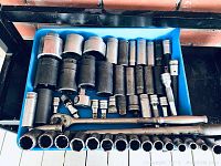 Top-down view of blue tray holding assorted Snap-On sockets, extensions, ratchet and breaker bar