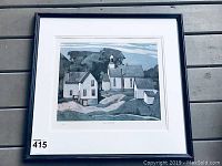 Framed AJ Casson print showing a landscape of houses and church