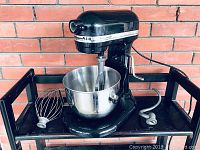 Full view of mixer on cart with bowl and attachments on either side