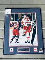 Overall view of framed signed photo with mat and plaque