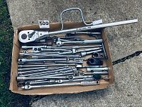 Photo showing a box containing multiple socket wrench handles, extensions, and a large grays 4254 ratchet wrench.