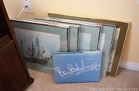 Five framed prints along with a signed art book, showing marine scenes by Ben Babelowsky
