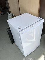 White Danby bar fridge closed, showing clean exterior and overall good condition.