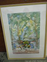 Framed original watercolor painting titled Symphonie Florale depicting floral market scene under trees.