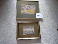Two framed Chinese prints on carpeted floor, showing front view of both artworks.