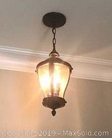Lamp hanging and lit in ceiling, showing overall look and illumination.