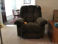 Front view of rocker recliner in upright position showing cushioned armrests and backrest.