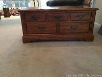 Front view of Broyhill wooden table showing five drawers and overall design