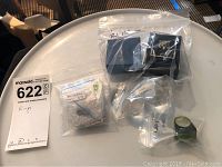 Overview of all items in sealed bags and boxes on white table
