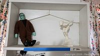 Herman Munster doll in brown suit and black shoes with Art Deco diver statue in a box
