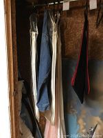 Photo of hanging denim jean jackets and vintage lingerie dresses inside closet space.