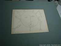 Photo of Picasso reproduction print showing sun-like face, bird, and fish with signature Picasso Avril 42