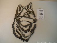 Front view of the wolf's head metal wall art, showing detailed cut-out design on bare steel.