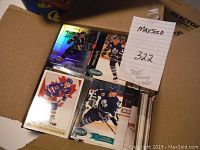 Image showing a box with various hockey cards including Toronto Maple Leafs players, some holographic cards visible