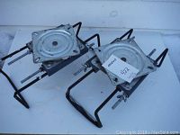 Pair of used adjustable aluminum boat swivel seat bases showing square swivel plates and black metal frames