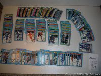 Top-down view showing a large spread of hockey trading cards laid out on a surface, organized in rows by team and player.