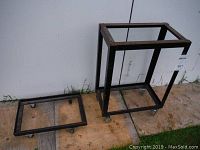 Two homemade black metal tool stands on caster wheels, one tall rectangular frame (29.5 inches tall) and one low rectangular frame, both with a welded metal square tubing construction.