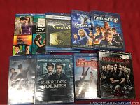 Full lot of 10 Blu-rays arranged on red fabric background showing titles and packaging.