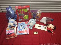 Full lot overview showing all toys and items arranged on a red surface