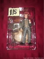 Photo showing the main figure and accessories in clear plastic packaging with a $15 price tag.