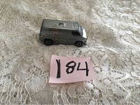 Photo of vintage Hot Wheels 1974 model California Cruisin Van with visible wear and paint loss on lace fabric background.