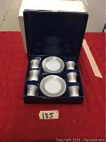 Full view of espresso cup set in blue box showing six cups and six saucers.